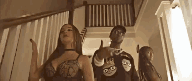 a man and two women are standing on a set of stairs