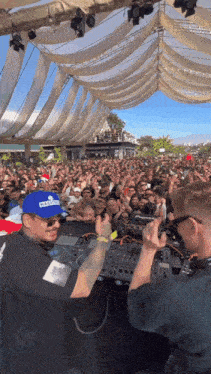 a dj wearing a blue hat that says ' norwegian ' on it