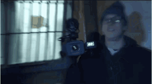a man is holding a camera that says ' ii ' on it
