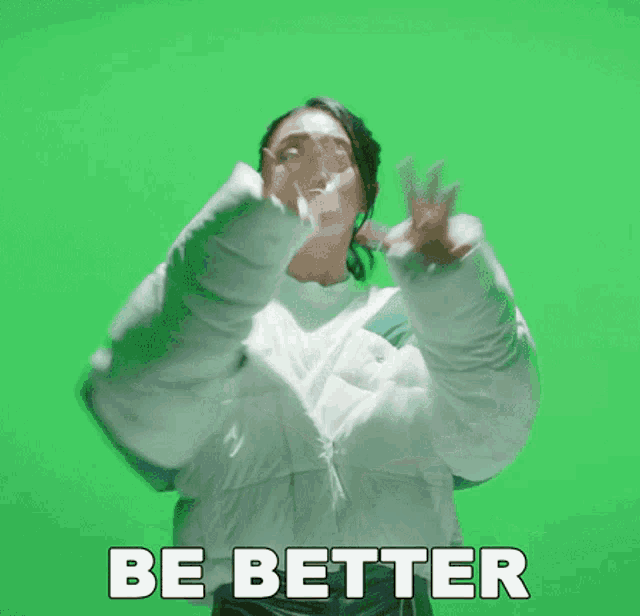a woman in a white jacket says " be better " on a green screen