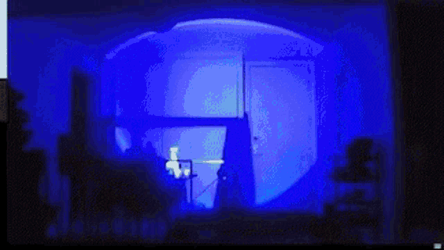 a blue light is shining on a person 's head