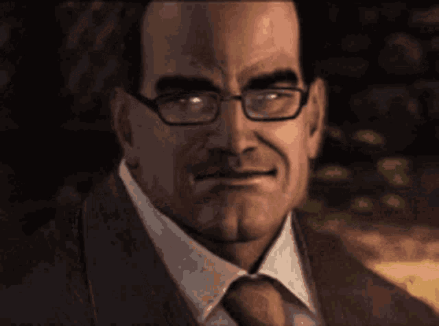 a man wearing glasses and a suit and tie is smiling