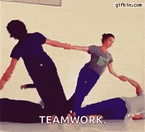 a group of people are doing a trick on each other while holding hands and the word teamwork is written on the bottom .