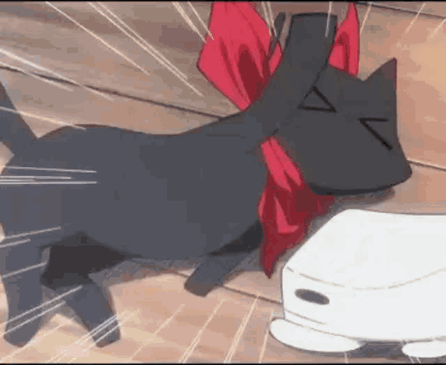 a black cat with a red bow is laying on a wooden floor next to a white box .