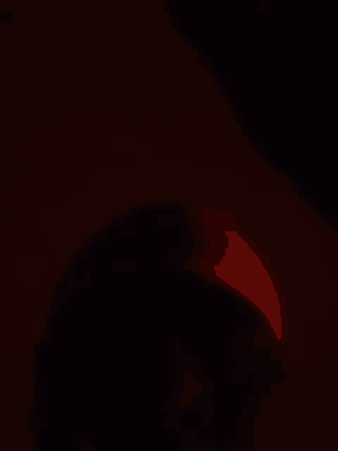 a red light is coming out of a dark room