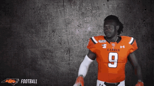 a football player wearing an orange jersey with the number 9