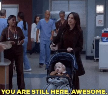 a woman pushing a baby in a stroller with the words " you are still here awesome " behind her