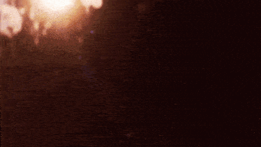 the sun is shining brightly in the dark and the rain is falling .