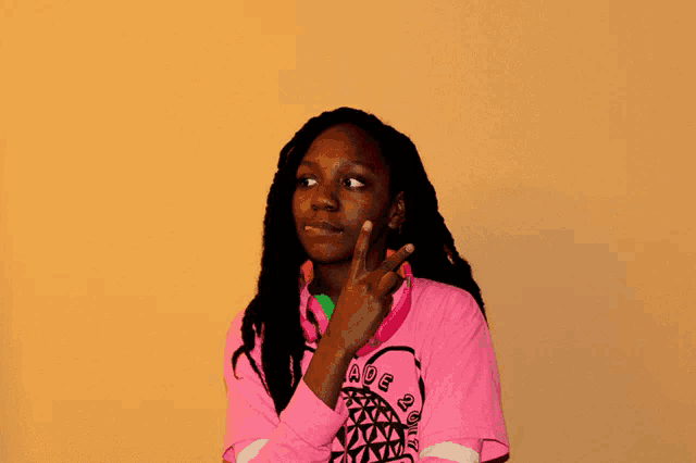 a girl wearing headphones and a pink shirt that says 6th grade