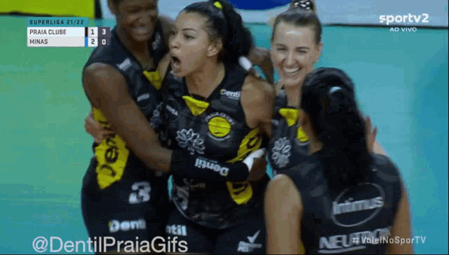 a group of female volleyball players are hugging each other on a sports tv screen