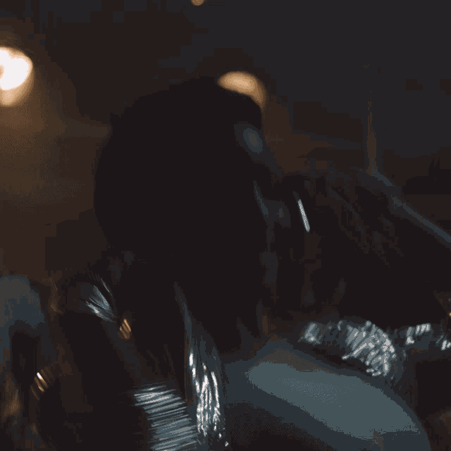 a blurry photo of a woman 's face with her hands in the air