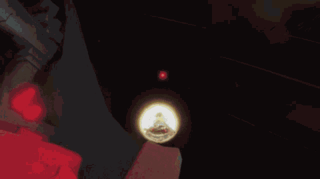 a person is standing in a dark room with a glowing light behind them