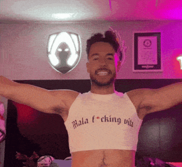 a man wearing a crop top that says mala fucking vila
