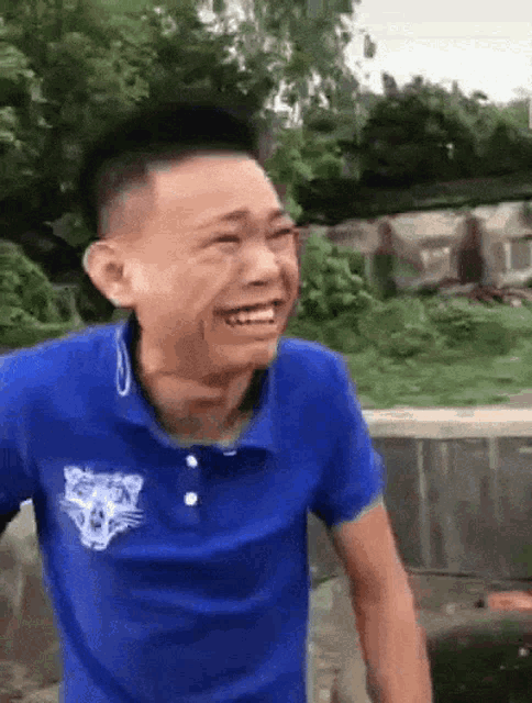 a man in a blue shirt with a tiger on it