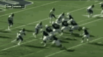 a group of football players are running on a field with a cnn sports logo in the background