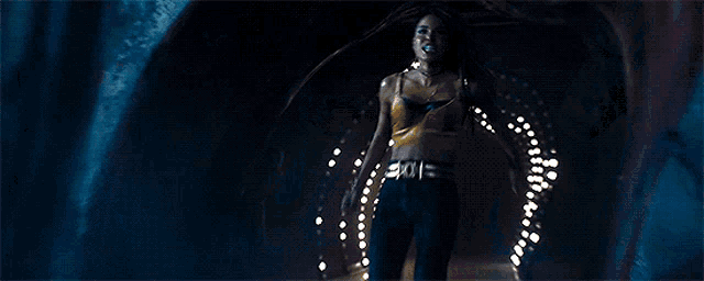 a woman is screaming in the dark with her mouth open