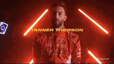 a man in a red outfit with the name tanner thomson written above him