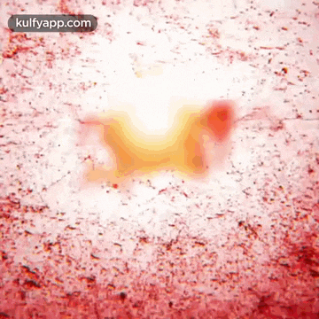 a close up of a red and white background with a yellow spot in the middle .