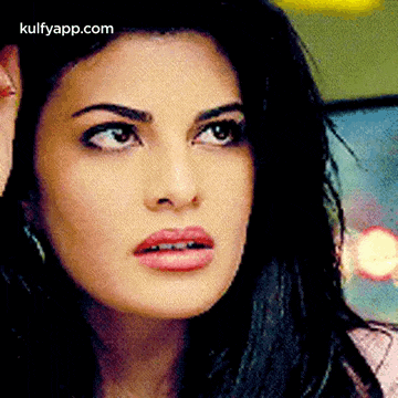 a close up of a woman 's face with a surprised look on her face