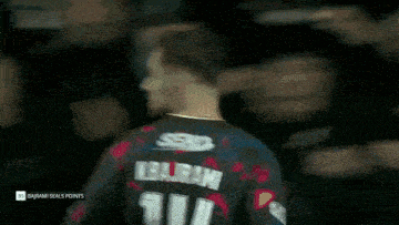 a man wearing a jersey with the number 14 on the back