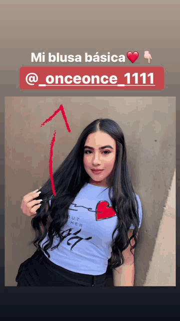 a woman wearing a blue shirt with a red heart on it