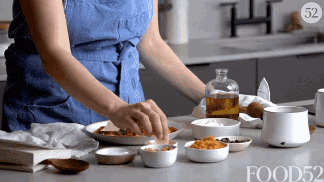 a woman prepares food in a kitchen with food52 on the bottom right