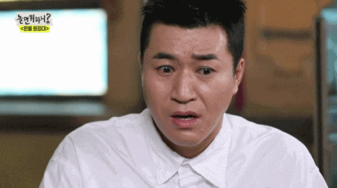 a man in a white shirt making a funny face