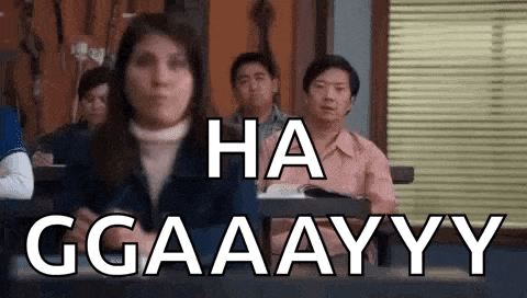 a group of people are sitting at desks in a classroom with the words `` ha ggaaayyy '' .