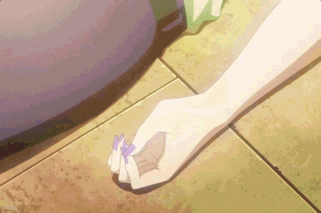 a woman 's hand is holding a purple flower in her hand