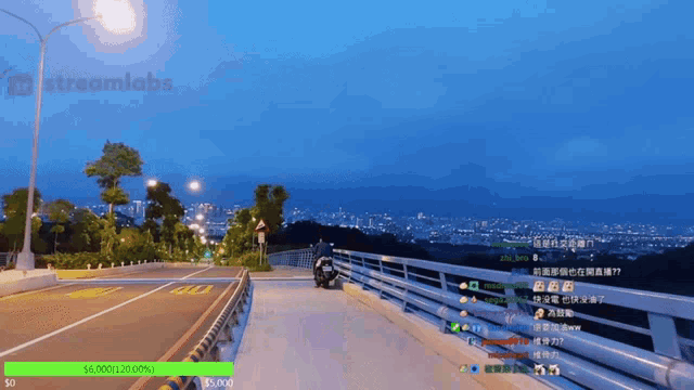 a streamlabs screen shows a person riding a motorcycle on a bridge at night