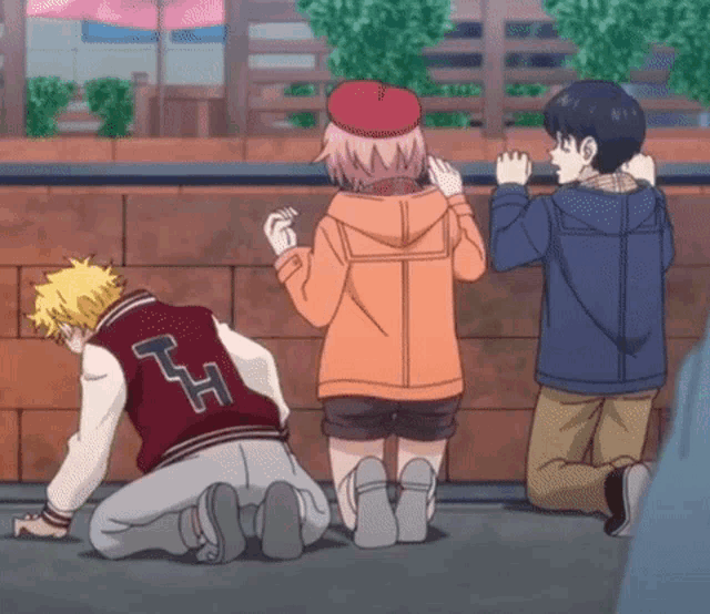 a group of anime characters are kneeling down on the ground and one of them has a letter h on his back .