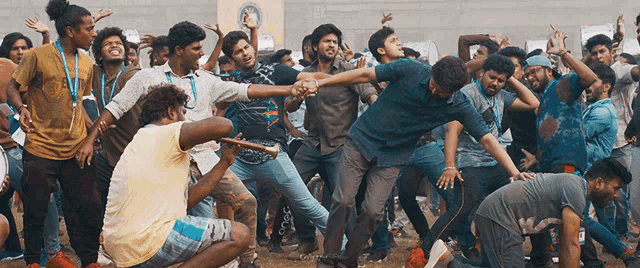 a group of young men are dancing in a stadium .