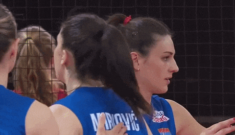 a female volleyball player wearing a blue jersey with the name mrovic on the back