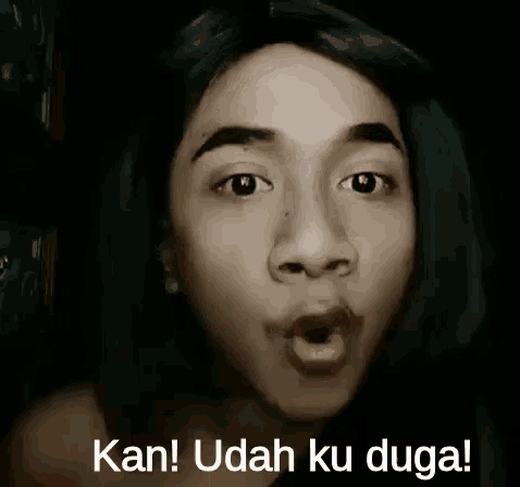 a man is making a funny face with his mouth open .