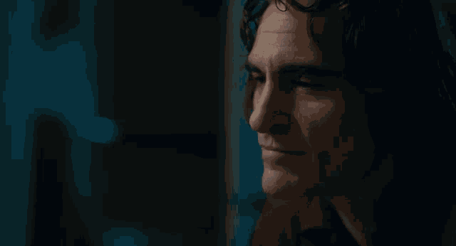 a close up of a person 's face with a blue background