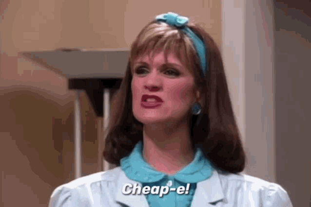a woman is making a funny face and saying `` cheap-e '' while wearing a blue headband .