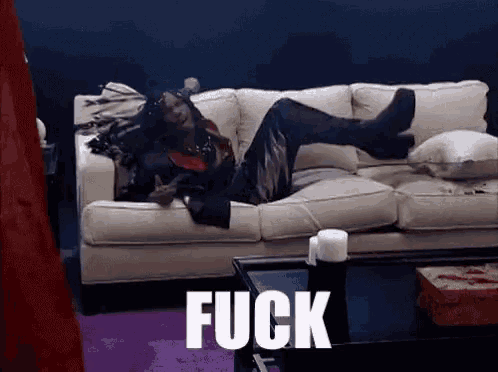 a person is laying on a couch with the word fuck written on the bottom
