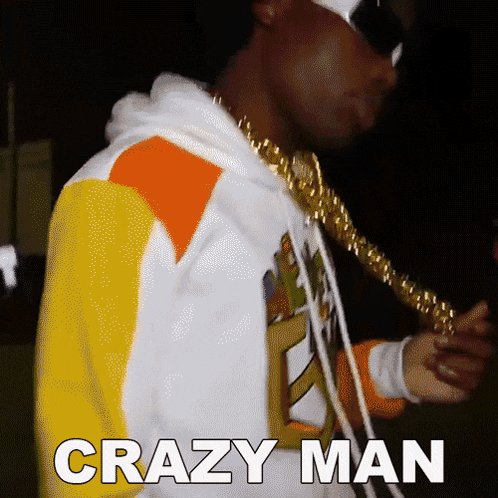 a man wearing a hoodie and a gold chain has the words crazy man written on his back