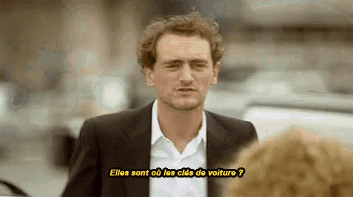 a man in a suit is talking to another man in a white shirt .