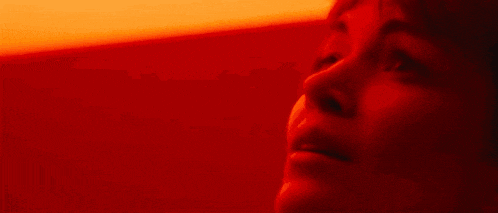 a close up of a woman 's face with her eyes closed .