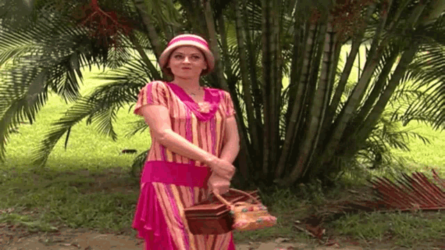a woman in a pink striped dress holds a basket