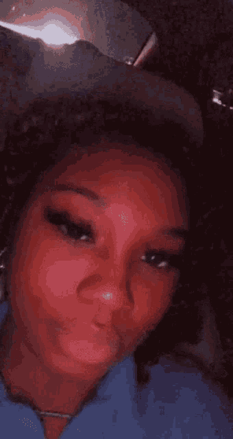 a close up of a woman 's face with a hat on