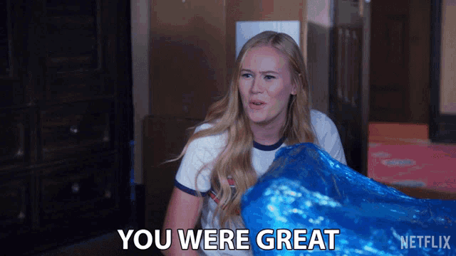 a woman holding a blue bag that says you were great on it