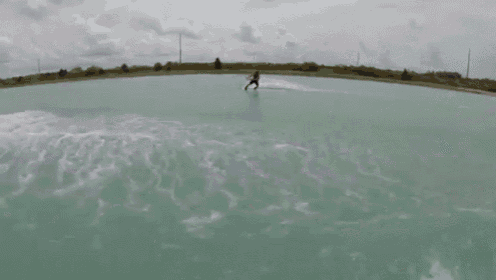 a man is riding a surfboard in the air with a sticker on it that says ' supreme '