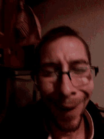 a close up of a man 's face with his eyes closed
