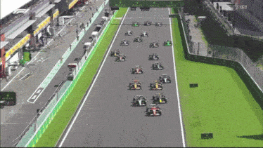a row of race cars on a track with rolex signs