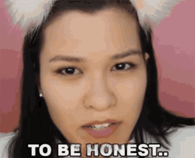 a woman wearing a cat ear headband says " to be honest "