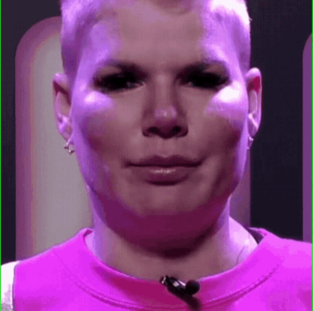 a close up of a woman 's face with a microphone in her mouth .