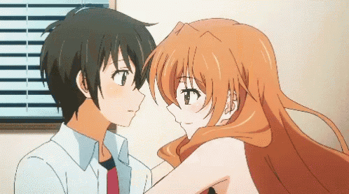 a boy and a girl are touching their foreheads in a room