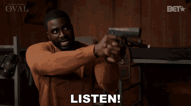 a man holding a gun with the word listen written below him
